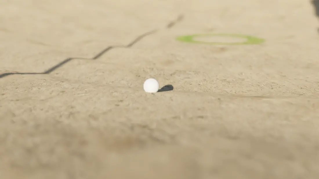 A ball sitting in the rake lines of the bunker
